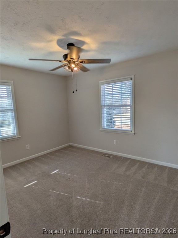 15 Happy Valley Drive Spring Lake, NC 28390 - Photo 7 of 16 an empty room with windows and fan
