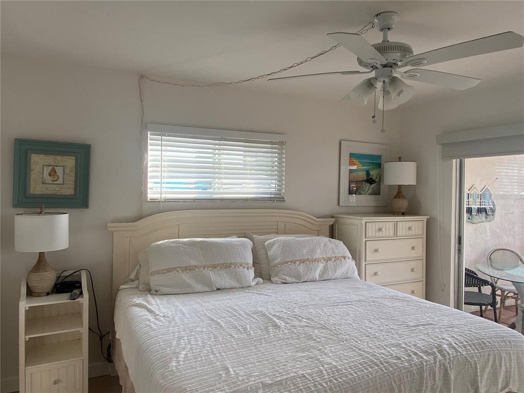 9200 Midnight Pass Road, Unit 10 Sarasota, FL 34242 - Photo 11 of 26 a bedroom with a bed and a window