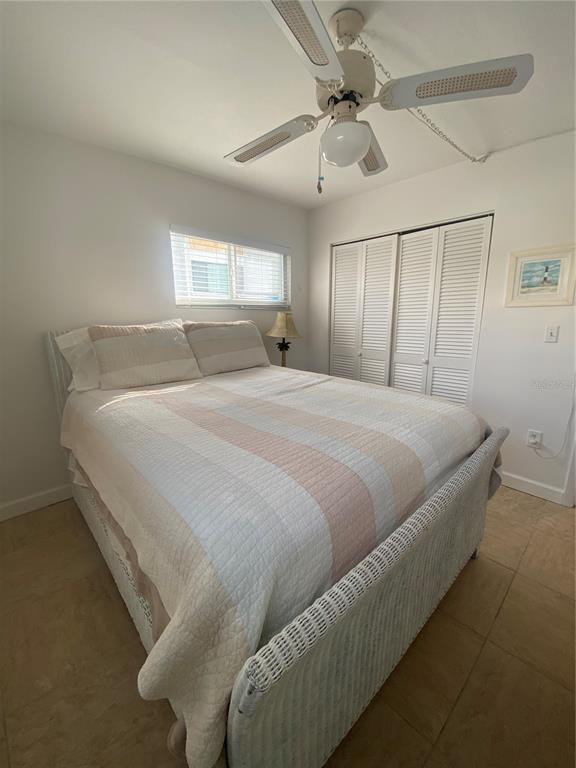 9200 Midnight Pass Road, Unit 10 Sarasota, FL 34242 - Photo 15 of 26 a bedroom with a bed and a chandelier