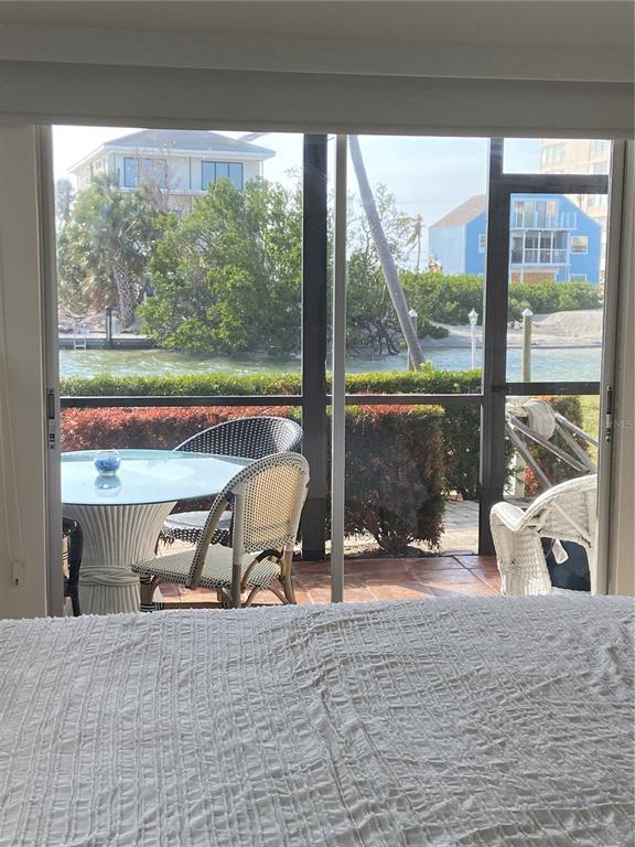 9200 Midnight Pass Road, Unit 10 Sarasota, FL 34242 - Photo 20 of 26 a view of a floor to ceiling window and a table