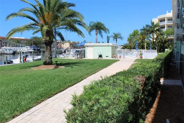 a front view of a house with a garden and patio
