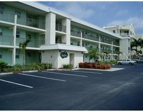 9200 Midnight Pass Road, Unit 10 Sarasota, FL 34242 - Photo 26 of 26 a view of a building with a garden