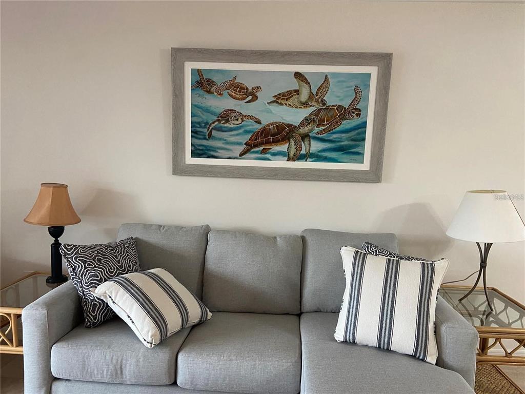 9200 Midnight Pass Road, Unit 10 Sarasota, FL 34242 - Photo 6 of 26 a bedroom with a bed and a lamp on dresser