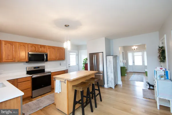 a large kitchen with a sink and cabinets