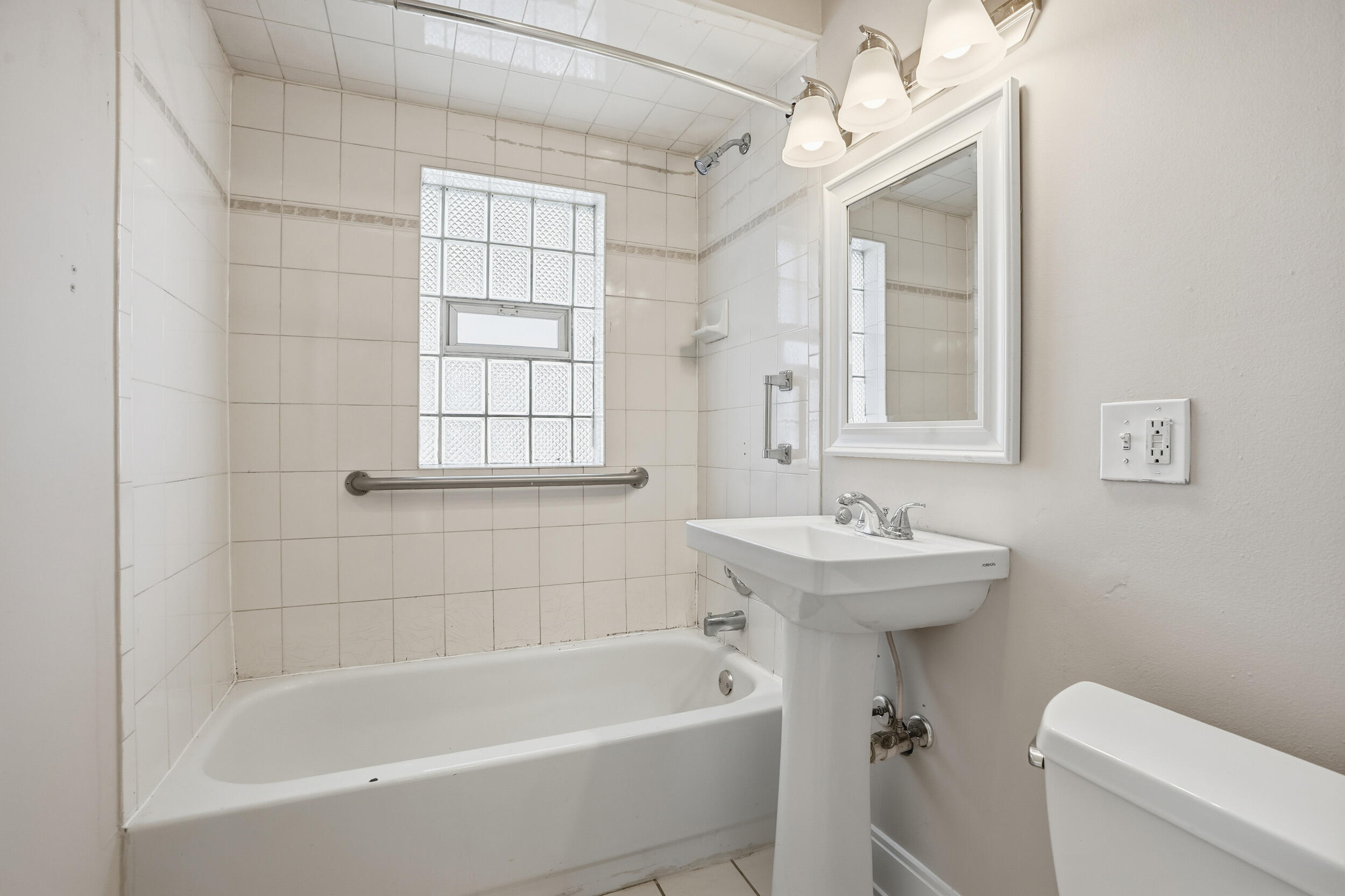 2731 Strong Street Highland, IN 46322 - Photo 12 of 16 a bath room with a toilet a bath tub and a sink