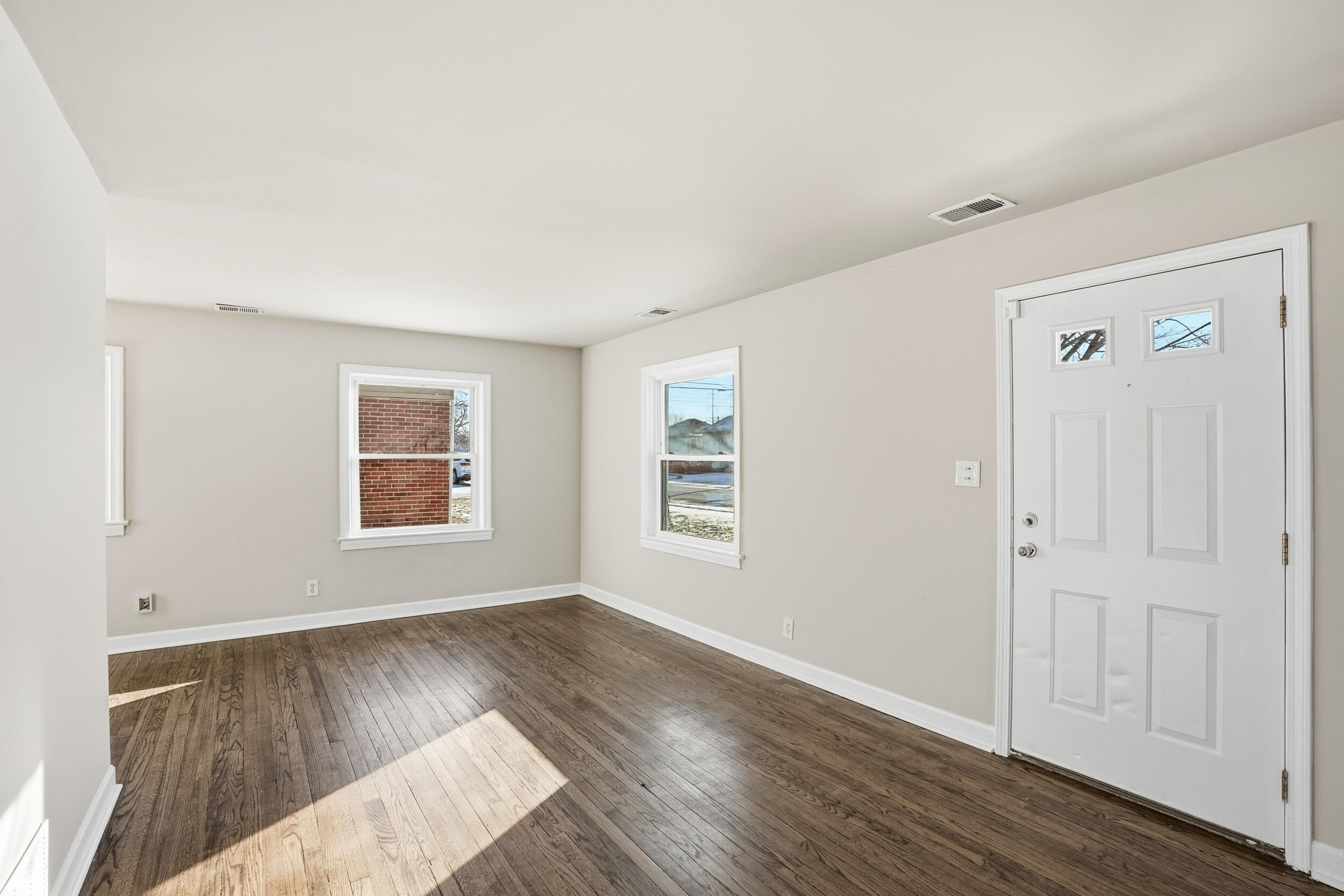 2731 Strong Street Highland, IN 46322 - Photo 3 of 16 an empty room with wooden floor and windows