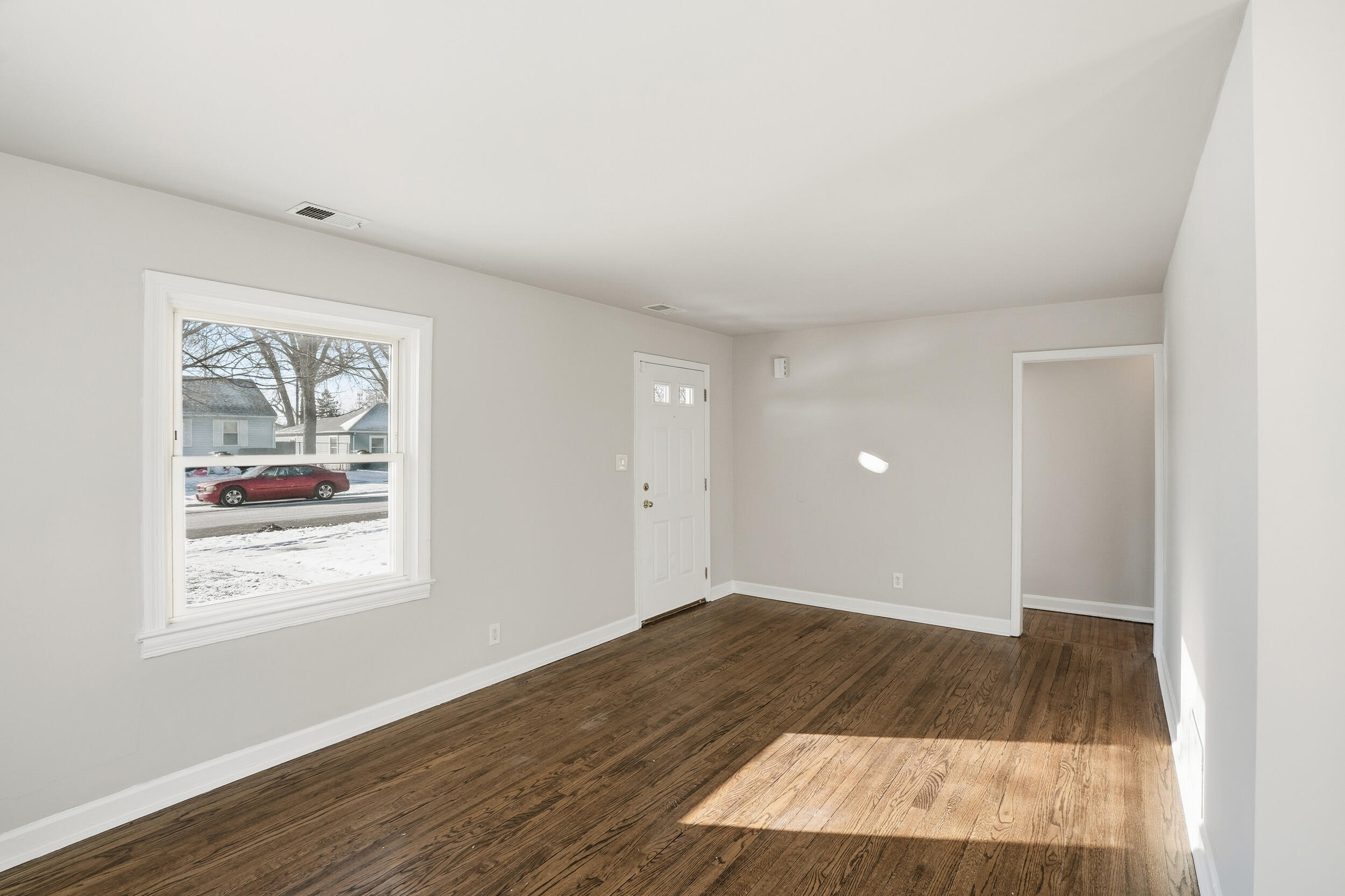 2731 Strong Street Highland, IN 46322 - Photo 4 of 16 an empty room with wooden floor and windows