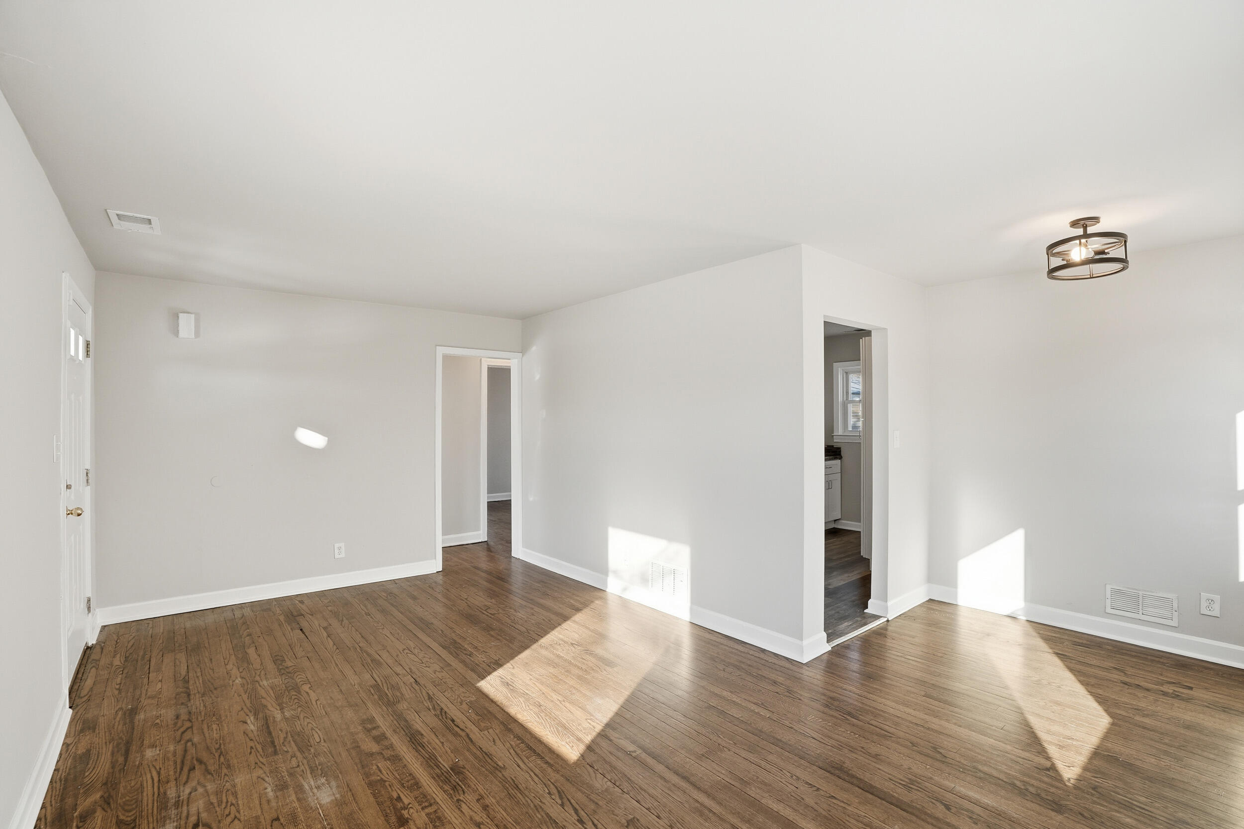 2731 Strong Street Highland, IN 46322 - Photo 5 of 16 a view of an empty room with wooden floor and a ceiling fan