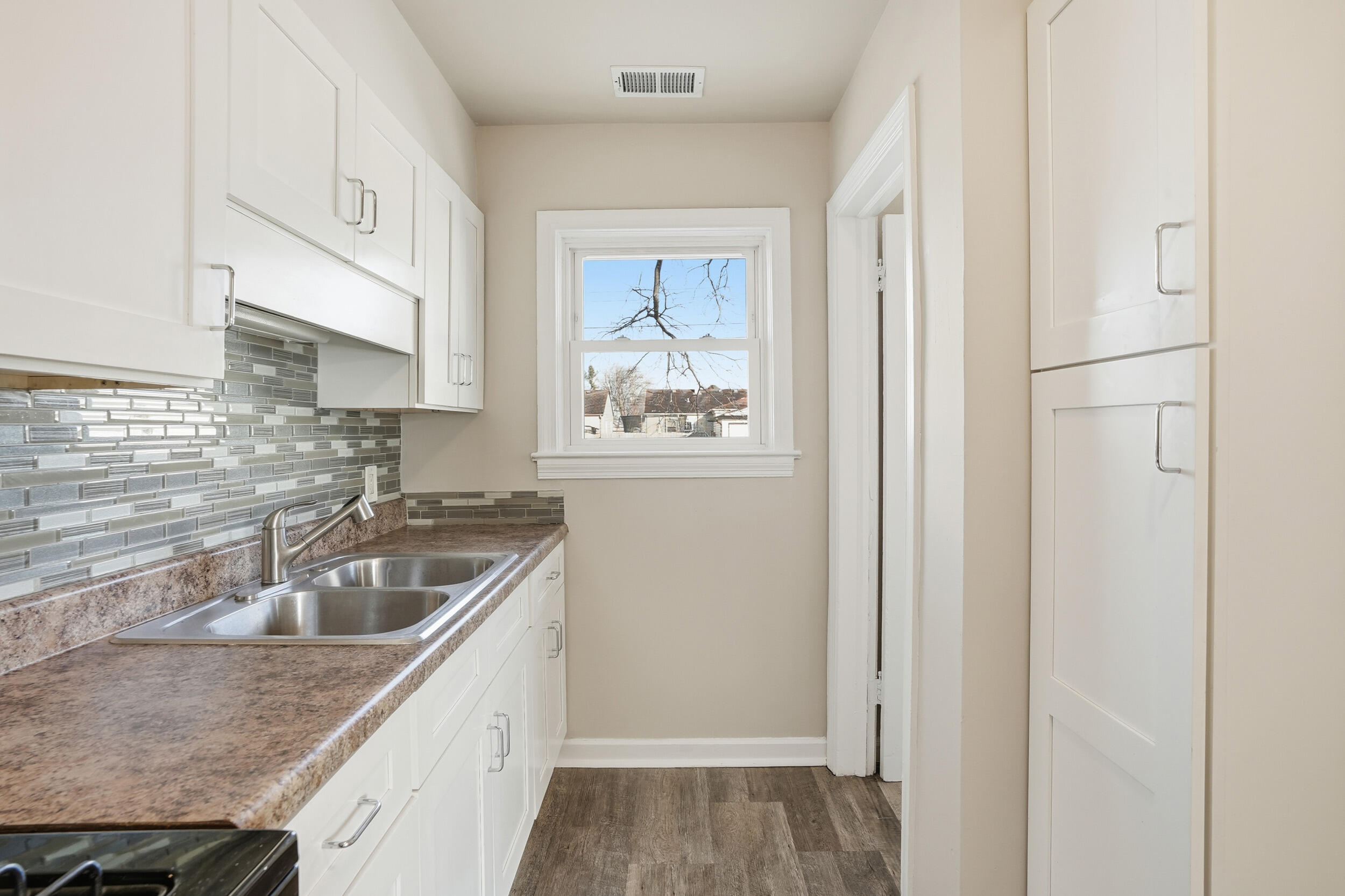 2731 Strong Street Highland, IN 46322 - Photo 9 of 16 a kitchen with stainless steel appliances granite countertop a sink stove and refrigerator