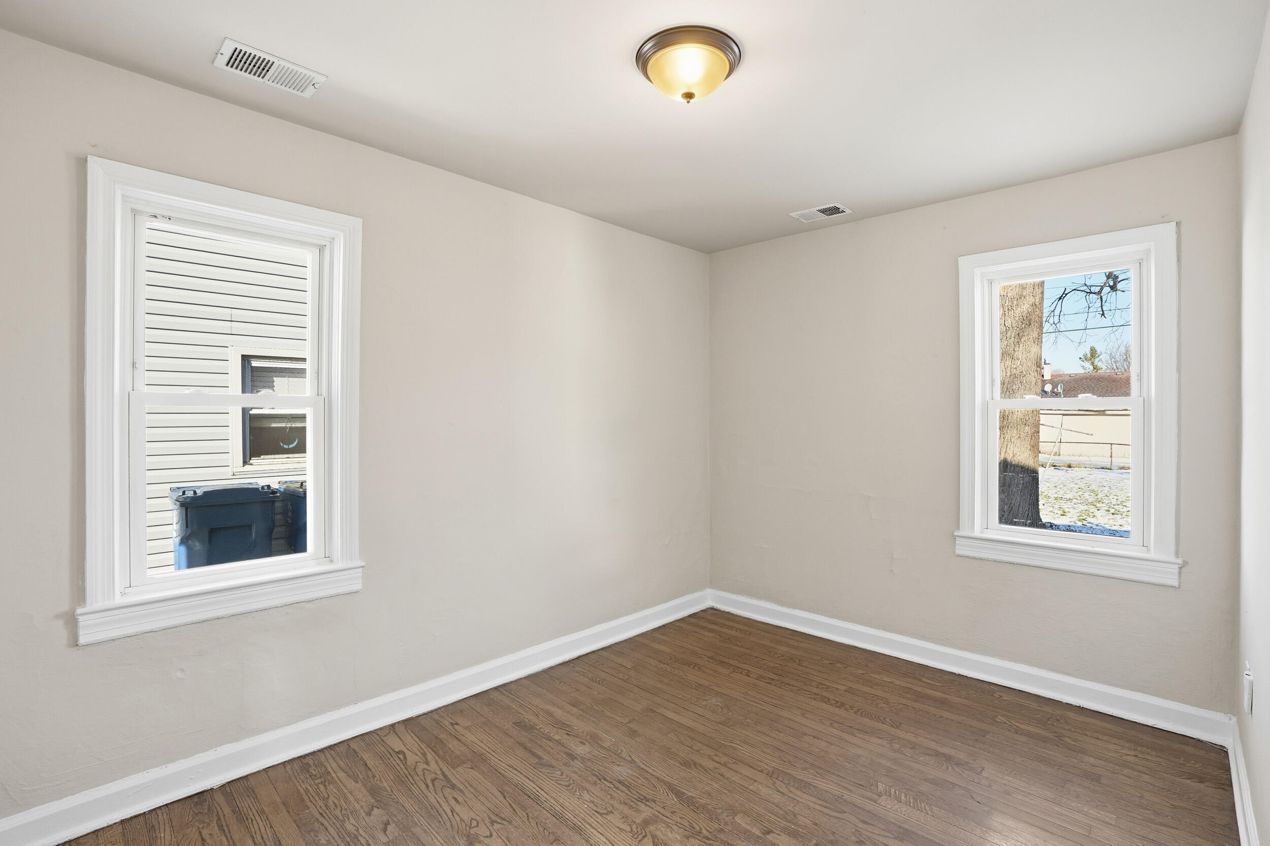2731 Strong Street Highland, IN 46322 - Photo 10 of 16 an empty room with wooden floor and windows