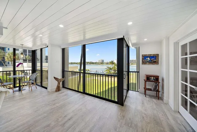 a view of a balcony with chairs and a potted plant