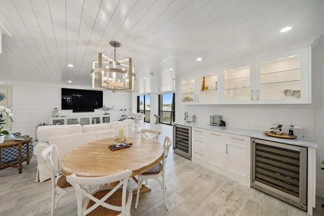 a kitchen with stainless steel appliances a dining table and chairs