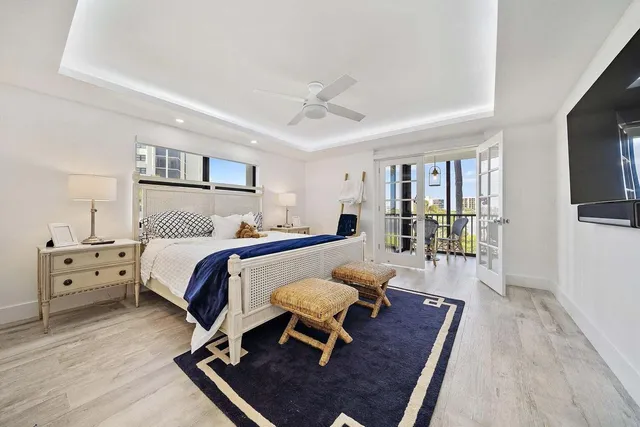 a bedroom with furniture and a large window