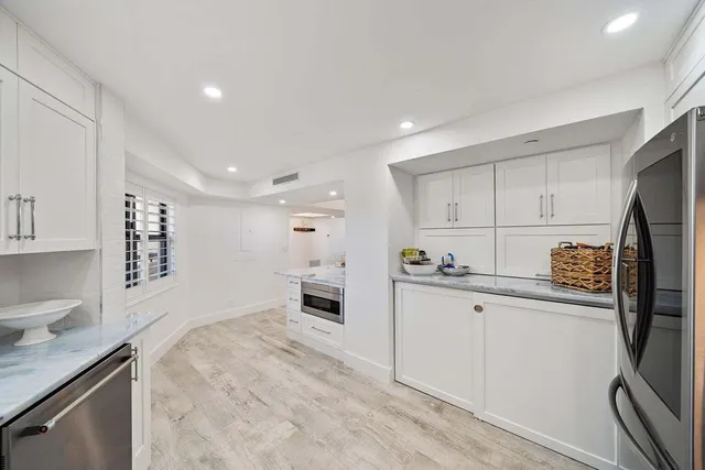 a kitchen with stainless steel appliances a refrigerator sink and stove