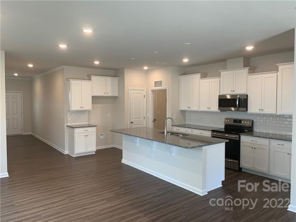 6512 Gopher Road, Unit 320 Lancaster, SC 29720 - Photo 2 of 12 a large kitchen with stainless steel appliances granite countertop a stove a sink and a refrigerator