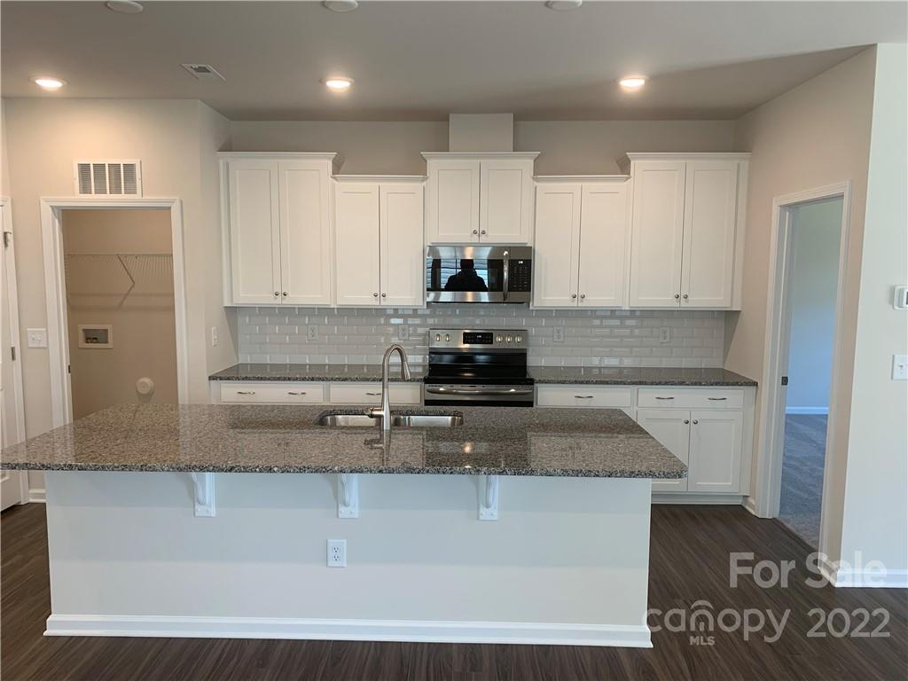 6512 Gopher Road, Unit 320 Lancaster, SC 29720 - Photo 3 of 12 a kitchen with kitchen island a counter top space and cabinets