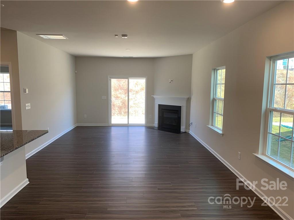 6512 Gopher Road, Unit 320 Lancaster, SC 29720 - Photo 4 of 12 an empty room with wooden floor and windows