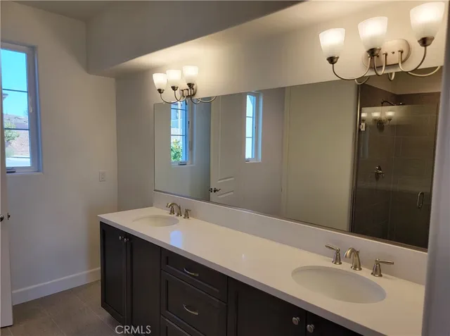 a bathroom with a sink double vanity and a mirror
