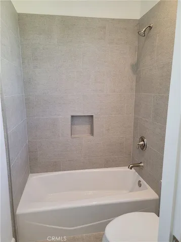 a bathroom with a bathtub and a toilet