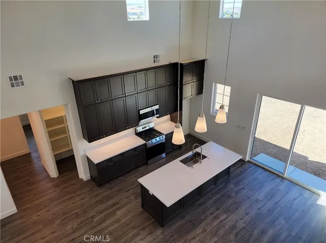 a living room with wooden floor and furniture