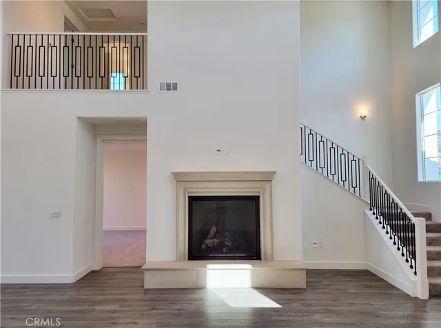 a view of a livingroom with stairs and a fireplace