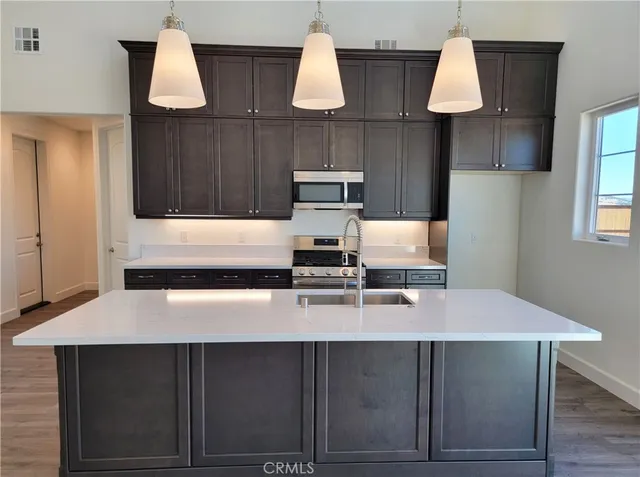 a kitchen with a table chairs and cabinets