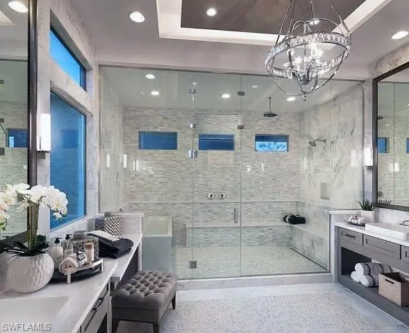 a en suite bathroom with a tub sink and mirror