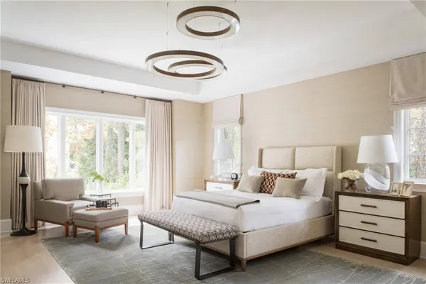 a spacious bedroom with a bed and a large window