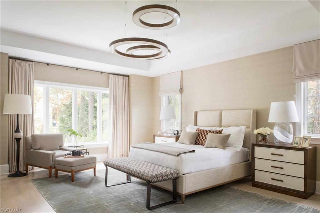 3898 Crayton Road Naples, FL 34103 - Photo 21 of 35 Photos are of a similar home by builder and are for illustrative purposes only. Bedroom featuring light wood-style flooring and baseboards.