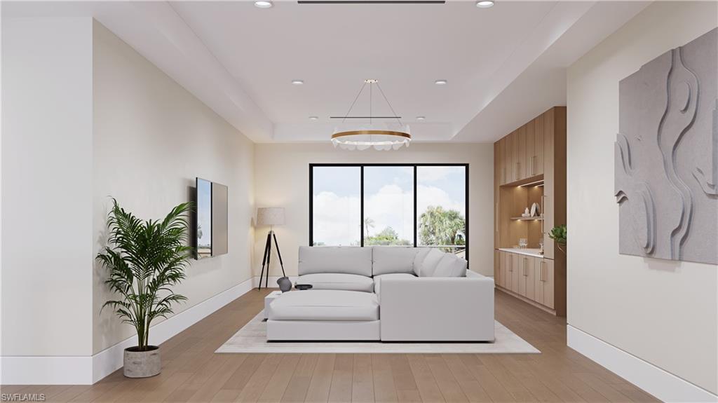 3898 Crayton Road Naples, FL 34103 - Photo 9 of 35 a living room with furniture large window and a potted plant