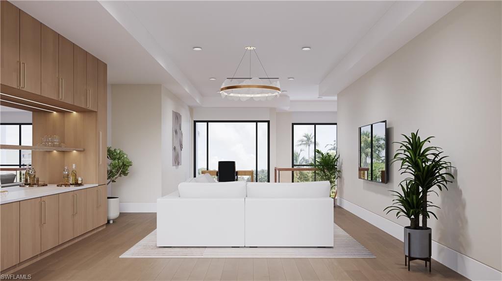 3898 Crayton Road Naples, FL 34103 - Photo 10 of 35 a living room with furniture and large windows