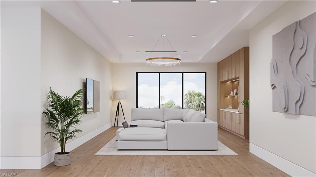 3898 Crayton Road Naples, FL 34103 - Photo 10 of 35 Architectural rendering. Plans and finishes can be customized. Upstairs living area with a raised ceiling, light wood-style floors, and recessed lighting.