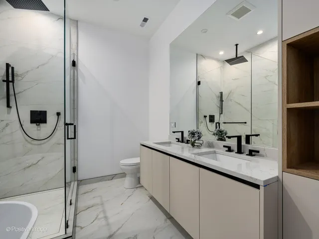 a bathroom with a granite countertop sink a toilet and a shower