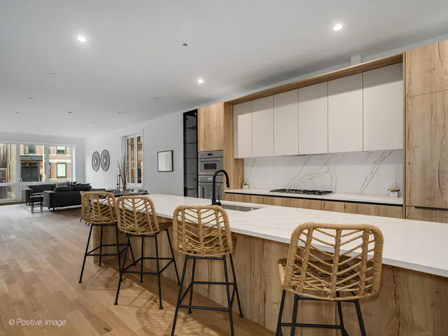 a kitchen with a table chairs stove and cabinets