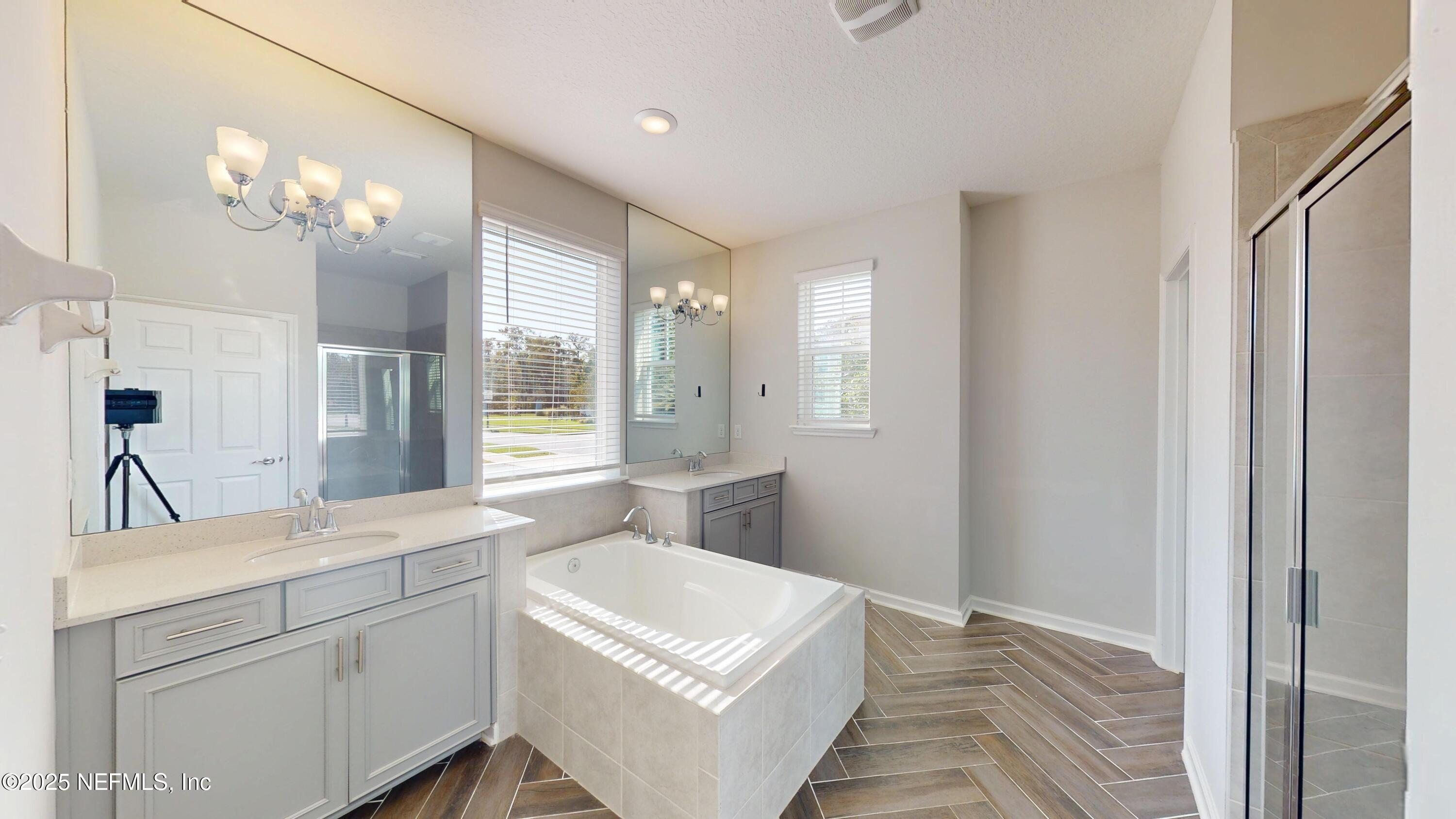 44 Footbridge Road St. Johns, FL 32259 - Photo 13 of 45 a spacious bathroom with a sink a large mirror and a shower