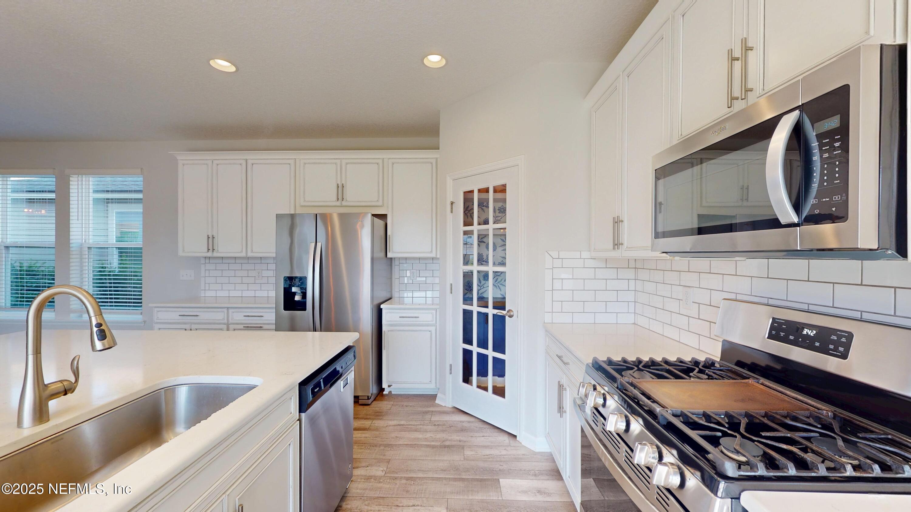 44 Footbridge Road St. Johns, FL 32259 - Photo 19 of 45 a kitchen with stainless steel appliances granite countertop a sink stove and refrigerator