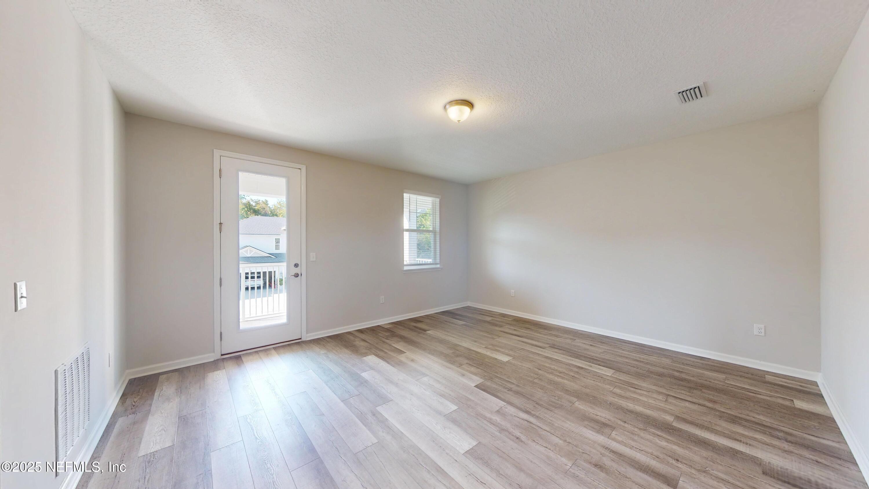 44 Footbridge Road St. Johns, FL 32259 - Photo 23 of 45 an empty room with wooden floor and windows