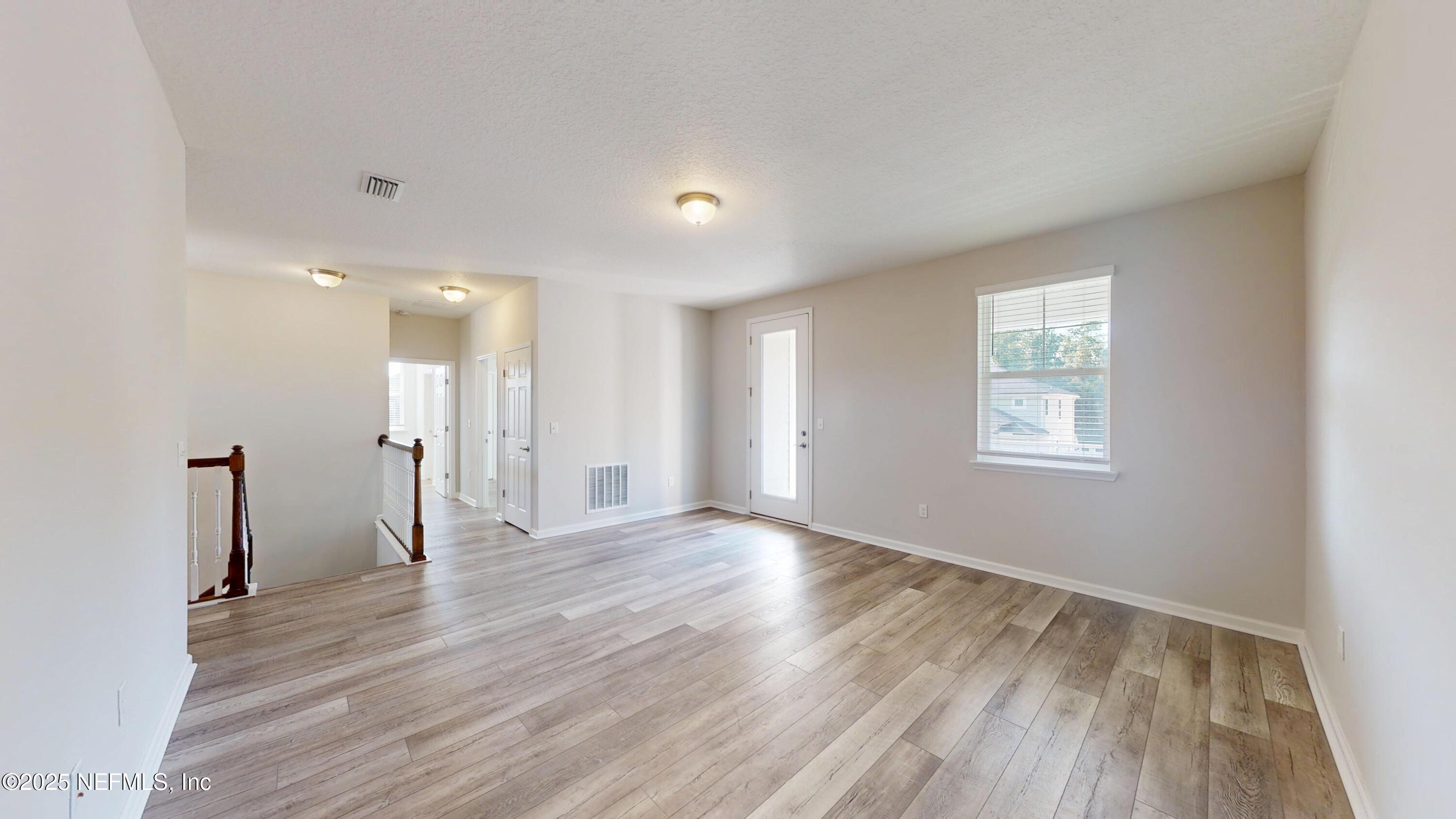 44 Footbridge Road St. Johns, FL 32259 - Photo 24 of 45 a view of an empty room with wooden floor and a window