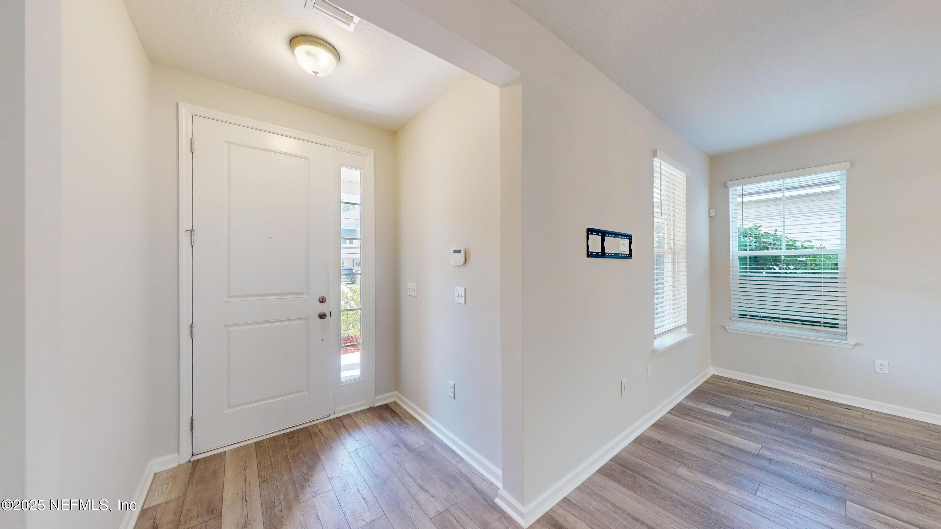 44 Footbridge Road St. Johns, FL 32259 - Photo 3 of 45 an empty room with wooden floor and windows
