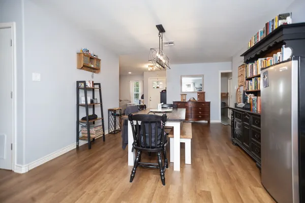 a dining room with furniture a rug and wooden floor