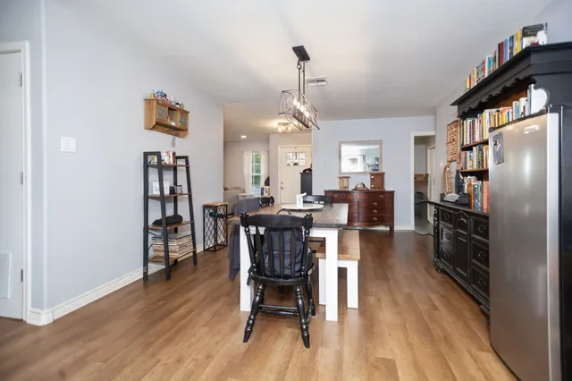 a dining room with furniture a rug and wooden floor