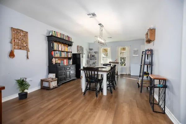 a dining room with furniture and wooden floor