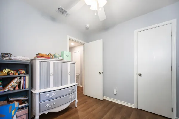 a view of room with cabinet and wooden floor