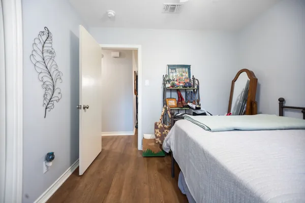 a bed room with a bed and a chair