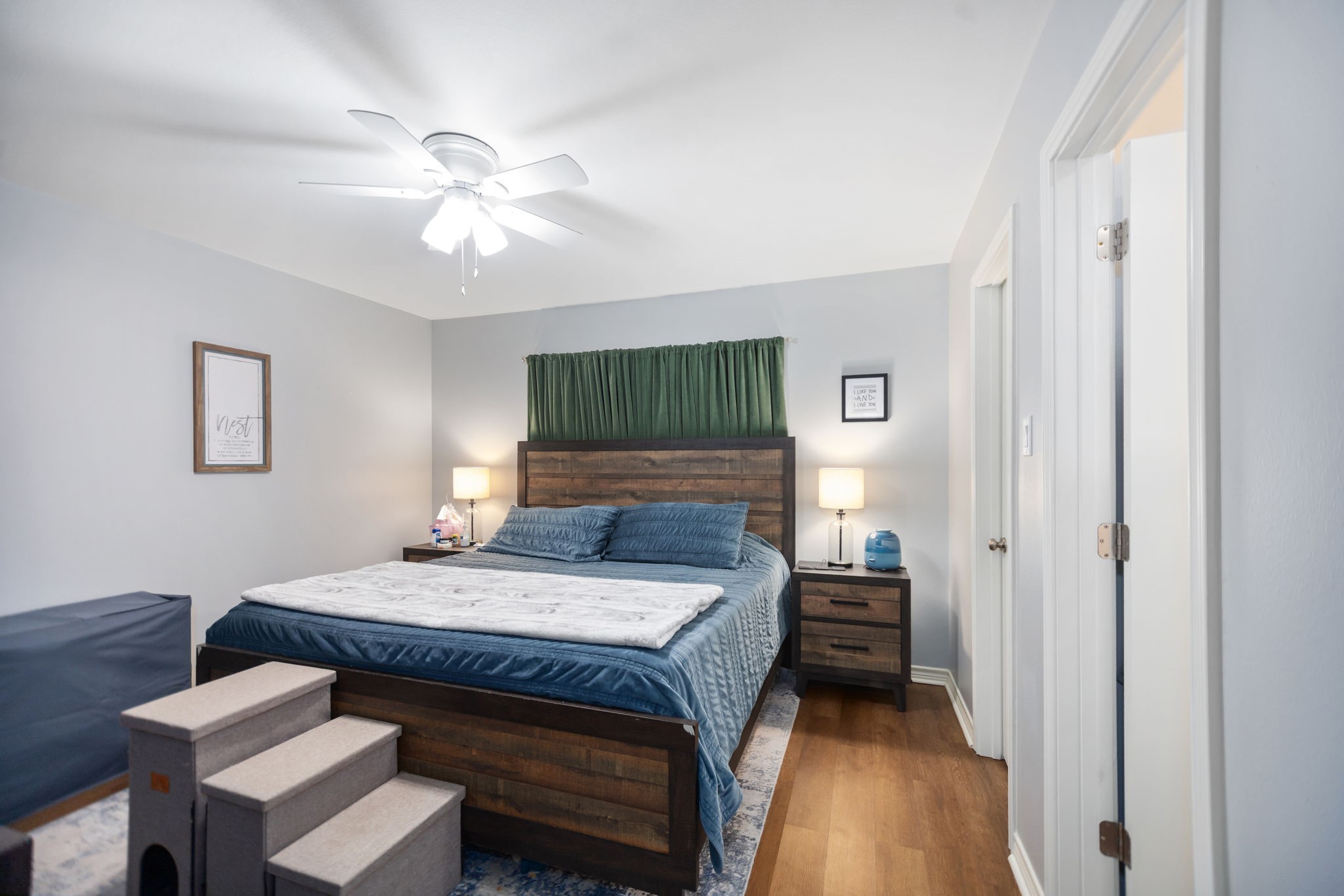 103 Quail Ridge Drive Nacogdoches, TX 75961 - Photo 21 of 28 a bedroom with a bed and a chandelier