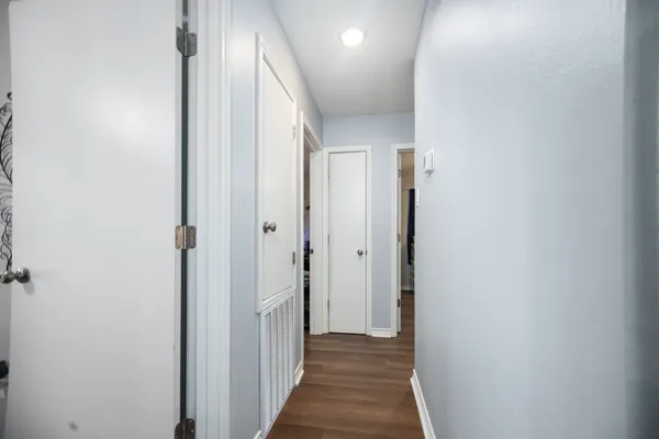 a view of a hallway with a wooden door