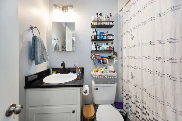 a white toilet sitting next to a bathroom sink