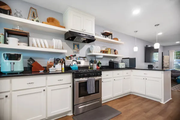 a kitchen with stainless steel appliances granite countertop a sink and cabinets