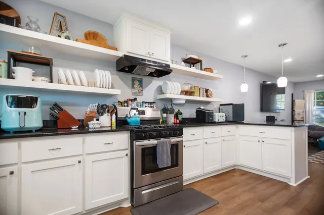 a kitchen with stainless steel appliances granite countertop a sink and cabinets