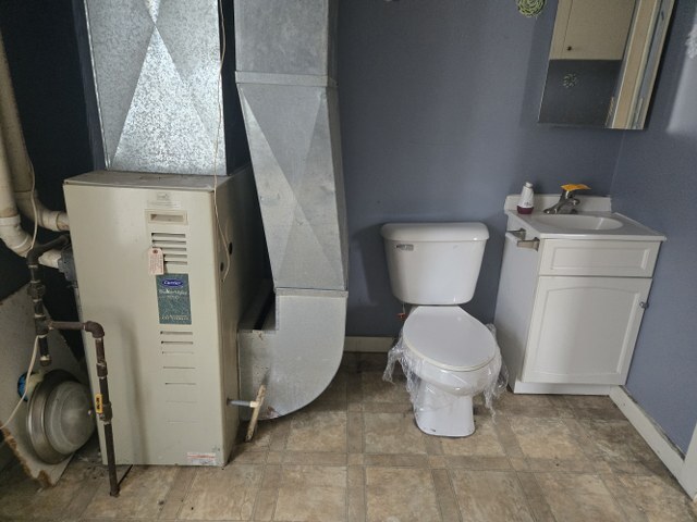 401 Northeast 3rd Street Aledo, IL 61231 - Photo 8 of 12 a bathroom with a toilet and a sink
